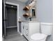 Well-lit bathroom with floating shelves, granite countertops, and modern fixtures; showcasing stylish design at 116 Carroll St, Temple, GA 30179