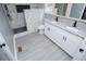 Bathroom boasts marble shower, double vanity, black matte fixtures, and vinyl floors at 116 Carroll St, Temple, GA 30179