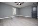 Bedroom featuring natural light, gray walls, vinyl floors, and ceiling fan at 116 Carroll St, Temple, GA 30179