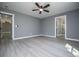 A spacious bedroom shows gray walls, vinyl flooring, and ensuite bathroom entrance at 116 Carroll St, Temple, GA 30179