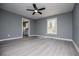 Spacious bedroom featuring a ceiling fan, natural light, and gray vinyl flooring at 116 Carroll St, Temple, GA 30179