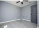 Bedroom featuring gray walls, vinyl flooring, a ceiling fan, and natural light at 116 Carroll St, Temple, GA 30179