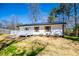 Charming home with white siding, shutters, and a lovely, inviting front porch at 116 Carroll St, Temple, GA 30179