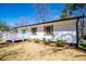 Charming exterior view of home with shutters, a lush lawn, and a welcoming deck at 116 Carroll St, Temple, GA 30179