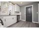 Updated kitchen features stainless steel appliances, gray countertops and white subway tile backsplash at 116 Carroll St, Temple, GA 30179