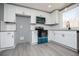 Bright kitchen with modern, stainless steel appliances, white cabinetry and gray countertop at 116 Carroll St, Temple, GA 30179