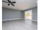 Bright living room with gray walls, ceiling fan, recessed lights and sliding glass door to a wooden deck at 116 Carroll St, Temple, GA 30179