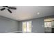 Bright living room features recessed lighting, ceiling fan and access to the outdoor deck through sliding glass doors at 116 Carroll St, Temple, GA 30179