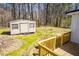 Backyard view featuring a deck and a storage shed with green grass at 116 Carroll St, Temple, GA 30179