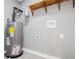 Utility room featuring the water heater with gray walls, white trim, luxury vinyl plank flooring and shelf at 116 Carroll St, Temple, GA 30179