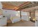 Comfortable loft bedroom featuring exposed beams, ensuite bathroom, and an open view to the living space below at 170 Boulevard Se # 104E, Atlanta, GA 30312