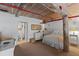 Cozy bedroom featuring a neutral color palette, rustic wooden beams, and a view to an ensuite bathroom at 170 Boulevard Se # 104E, Atlanta, GA 30312