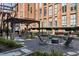 Outdoor lounge area with a pergola, stone fireplace, gravel and flagstone flooring and lush landscaping at 170 Boulevard Se # 104E, Atlanta, GA 30312