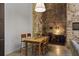 A cozy dining room featuring a wooden table, exposed brick wall, and modern lighting at 170 Boulevard Se # 104E, Atlanta, GA 30312