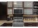 A stylish kitchen featuring stainless steel appliances, granite countertops, and dark wood cabinets at 170 Boulevard Se # 104E, Atlanta, GA 30312