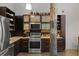 A modern kitchen featuring stainless steel appliances, dark wood cabinets, and a black subway tile backsplash at 170 Boulevard Se # 104E, Atlanta, GA 30312