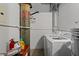 Bright laundry room featuring a newer washer and dryer set, plus storage shelves for added convenience at 170 Boulevard Se # 104E, Atlanta, GA 30312