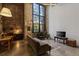 Spacious living room features exposed brick accent wall, large picture window and concrete floors at 170 Boulevard Se # 104E, Atlanta, GA 30312