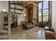 Loft living room boasts exposed brick, spiral staircase, a large window and industrial modern lighting fixture at 170 Boulevard Se # 104E, Atlanta, GA 30312