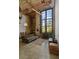 This loft living room features exposed brick, a huge window, modern lighting and concrete floors at 170 Boulevard Se # 104E, Atlanta, GA 30312