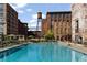 Inviting community pool with lounge chairs in a courtyard surrounded by historical architecture on a clear day at 170 Boulevard Se # 104E, Atlanta, GA 30312