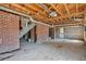Spacious basement with exposed brick walls, wood ceiling, and visible utilities, ready to be finished at 2696 Dodson Dr, East Point, GA 30344