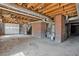 Unfinished basement with concrete floor, exposed ceiling, and brick supports awaiting customization at 2696 Dodson Dr, East Point, GA 30344