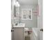 Bathroom with tub, sink and vanity, featuring neutral tile and classic fixtures at 2696 Dodson Dr, East Point, GA 30344