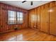 Charming bedroom featuring wood paneling, hardwood floors, and a window at 2696 Dodson Dr, East Point, GA 30344