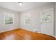 The bedroom has beautiful hardwood floors and two sunny windows, creating a warm and inviting space at 2696 Dodson Dr, East Point, GA 30344
