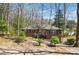 Charming brick home featuring classic architectural details, surrounded by mature trees and landscaping at 2696 Dodson Dr, East Point, GA 30344