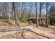View of the brick home from the driveway, surrounded by trees and greenery at 2696 Dodson Dr, East Point, GA 30344