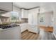 The kitchen has white cabinets and appliances, complemented by a view from the window at 2696 Dodson Dr, East Point, GA 30344