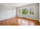 Bright living room featuring hardwood floors, light gray walls and a large picture window at 2696 Dodson Dr, East Point, GA 30344
