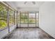 Bright sunroom featuring plank floors, a ceiling fan, and multiple windows providing natural light at 2696 Dodson Dr, East Point, GA 30344