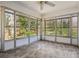 Enclosed sunroom with light gray plank floors and walls of windows offering serene views at 2696 Dodson Dr, Atlanta, GA 30344