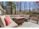 Spacious back deck featuring a sectional sofa and a wooden coffee table with a fire pit at 3222 Pagoda Trce, Lawrenceville, GA 30043