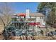 Exterior view of multi-level backyard deck with a hot tub, outdoor kitchen, and screened-in porch at 3222 Pagoda Trce, Lawrenceville, GA 30043