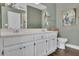 Neutral bathroom offers double sinks, a large vanity, and dark wood-look floors at 3222 Pagoda Trce, Lawrenceville, GA 30043