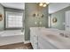 Bright bathroom with a soaking tub, double sinks, and a large mirror at 3222 Pagoda Trce, Lawrenceville, GA 30043