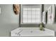 Corner soaking tub by a window creates a relaxing and bright bathroom space at 3222 Pagoda Trce, Lawrenceville, GA 30043
