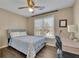 Bedroom with a window, ceiling fan, desk, and wood-look floors at 3222 Pagoda Trce, Lawrenceville, GA 30043