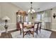 Elegant dining room with a chandelier, dining table with six chairs, and china cabinet at 3222 Pagoda Trce, Lawrenceville, GA 30043