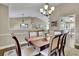 Dining room with a view to the living room, and an elegant dining table with six chairs at 3222 Pagoda Trce, Lawrenceville, GA 30043