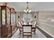 Dining room with a view to the stairway, a table with six chairs, and china cabinet at 3222 Pagoda Trce, Lawrenceville, GA 30043