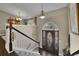 Inviting foyer with a decorative front door, staircase, and elegant lighting fixtures at 3222 Pagoda Trce, Lawrenceville, GA 30043