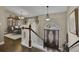 Spacious foyer featuring a decorative front door, staircase, and an elegant chandelier at 3222 Pagoda Trce, Lawrenceville, GA 30043