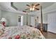 Bright main bedroom boasts tray ceilings, wooden floors, and ensuite bathroom access at 3222 Pagoda Trce, Lawrenceville, GA 30043