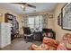 Well-lit office space features a desk, chair, bookcase, and organized shelving at 3222 Pagoda Trce, Lawrenceville, GA 30043