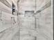 The shower includes gray veined tiles, a built-in niche, a bench, and a glass door at 3222 Pagoda Trce, Lawrenceville, GA 30043